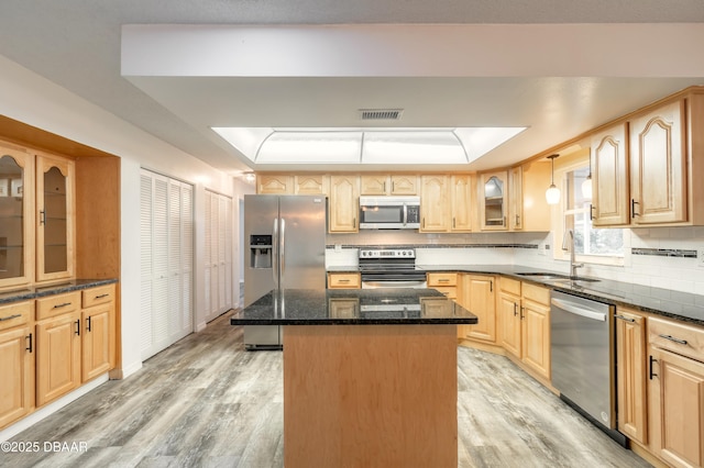 3643 Scott St, Port Orange, FL 32129 - kitchen with appliances with stainless steel finishes, light wood-style floors, a center island, and light brown cabinetry