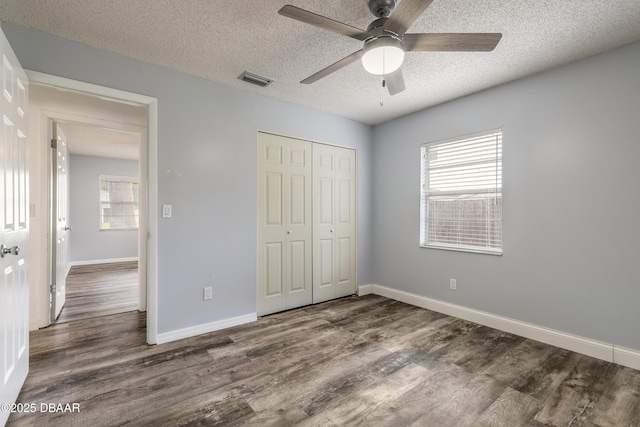 3643 Scott St, Port Orange, FL 32129 - unfurnished bedroom with wood finished floors, a textured ceiling, a closet, and ceiling fan