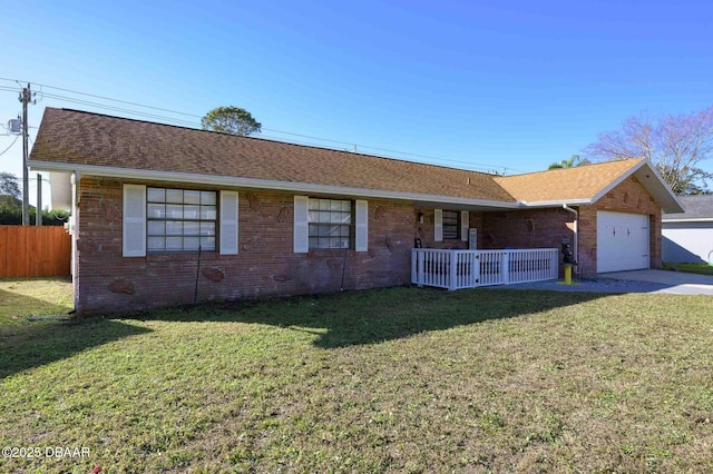 single story home with a porch, a garage, and a front yard