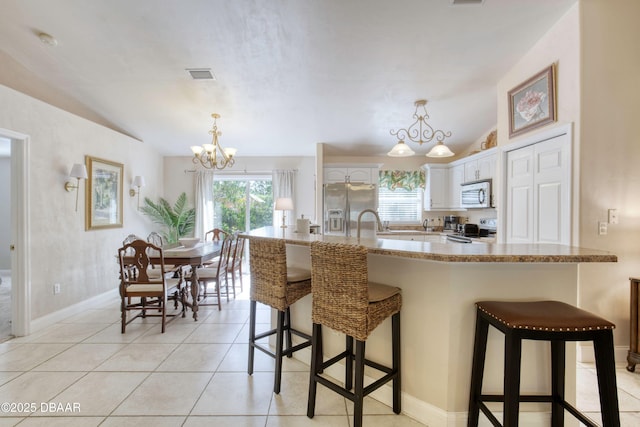 1465 Admiral Nimitz Ave, Daytona Beach, FL 32124 - kitchen with stainless steel appliances, healthy amount of natural light, vaulted ceiling, and a breakfast bar area