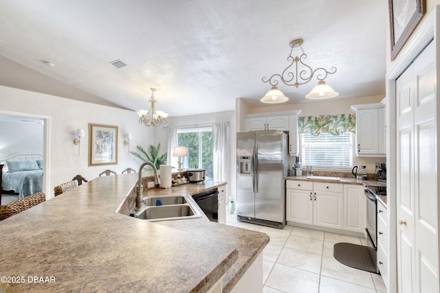 1465 Admiral Nimitz Ave, Daytona Beach, FL 32124 - kitchen with stainless steel fridge, a sink, a chandelier, dishwasher, and light tile patterned floors