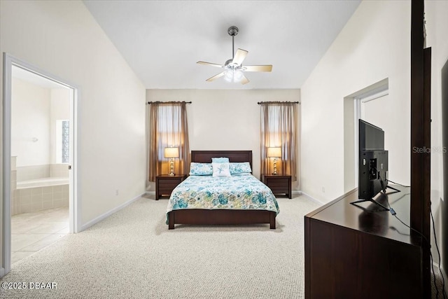 bedroom featuring connected bathroom, light colored carpet, and vaulted ceiling