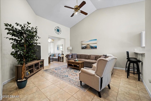 living room featuring light tile patterned floors, high vaulted ceiling, a ceiling fan, and baseboards