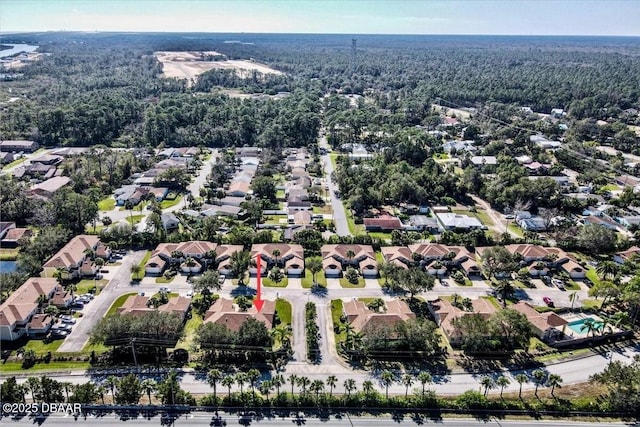 aerial view featuring a forest view and a residential view