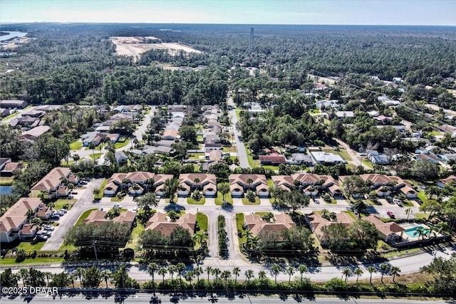 birds eye view of property featuring a residential view and a view of trees