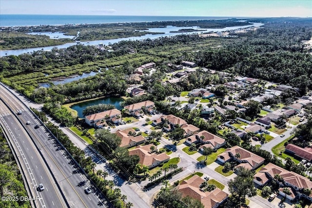 drone / aerial view with a water view and a residential view