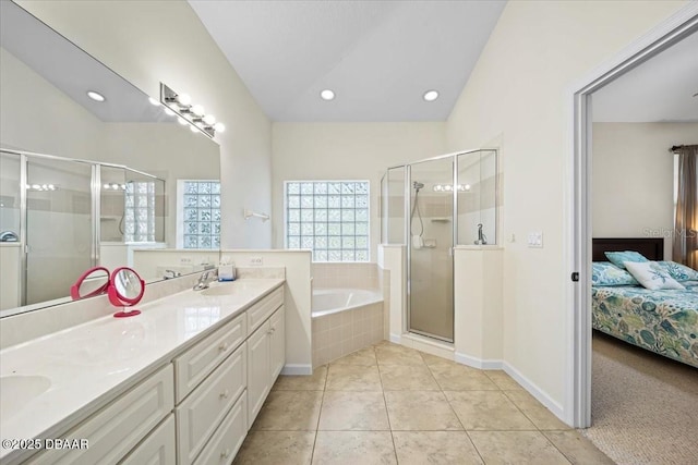 ensuite bathroom featuring a stall shower, ensuite bath, a sink, tile patterned flooring, and a bath