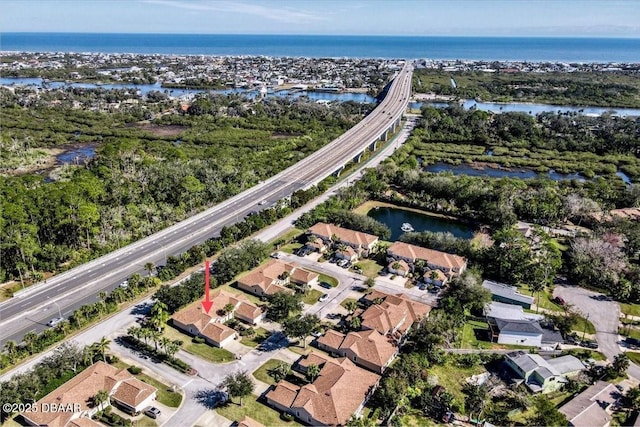 birds eye view of property with a water view and a residential view