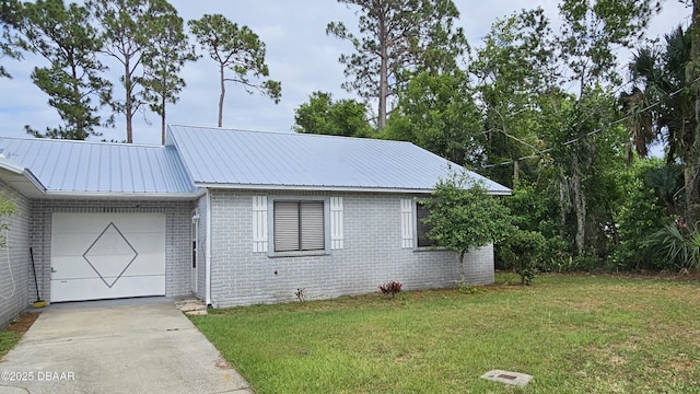 view of front of home with a garage and a front lawn