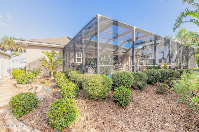 rear view of property featuring a lanai