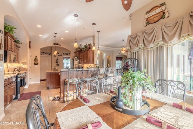 tiled dining space with ceiling fan