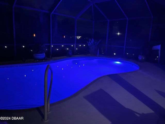 view of pool at night