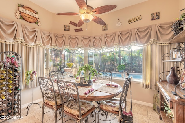 dining space featuring ceiling fan and light tile patterned flooring