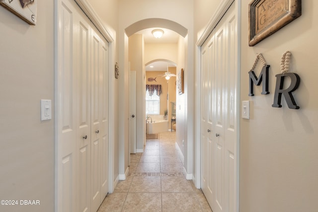 hall with light tile patterned floors