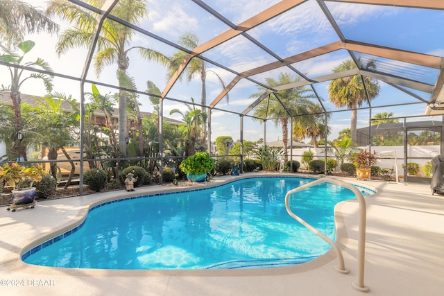 view of pool with a lanai and a patio area