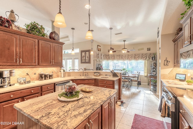 kitchen with pendant lighting, a center island, tasteful backsplash, and sink