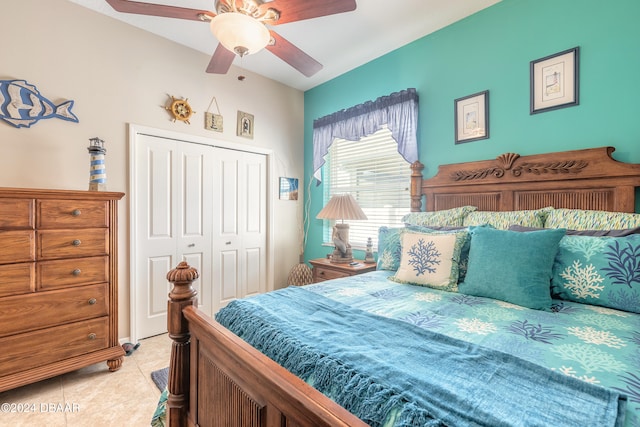 bedroom with light tile patterned flooring, a closet, and ceiling fan