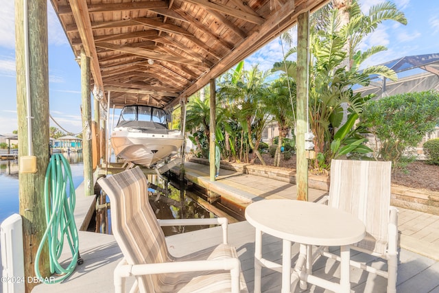 view of patio / terrace featuring a water view and a dock