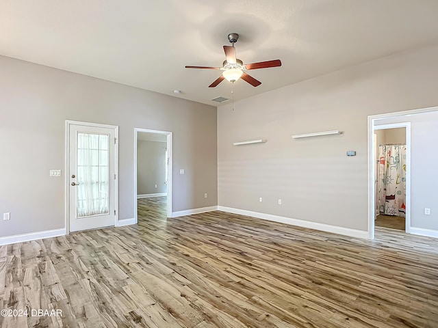 empty room featuring ceiling fan and light hardwood / wood-style floors