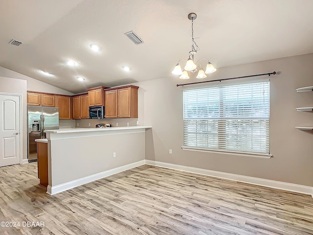 kitchen featuring a chandelier, stainless steel appliances, kitchen peninsula, pendant lighting, and lofted ceiling