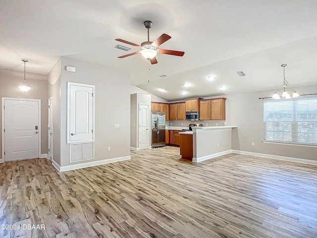 kitchen featuring stainless steel appliances, decorative light fixtures, ceiling fan with notable chandelier, and light wood-type flooring