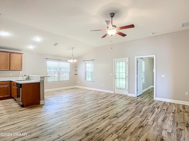 kitchen featuring lofted ceiling, light hardwood / wood-style flooring, ceiling fan with notable chandelier, stainless steel dishwasher, and pendant lighting