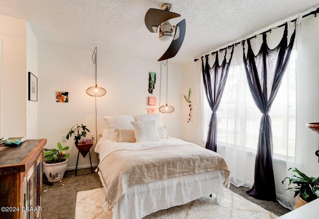 1600 Big Tree Rd Unit R4, Daytona Beach, FL 32119 - bedroom with carpet flooring, a textured ceiling, baseboards, and a ceiling fan