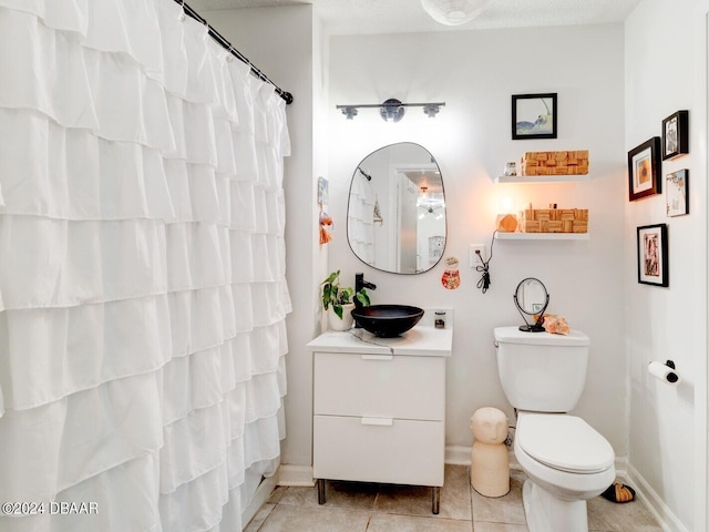 1600 Big Tree Rd Unit R4, Daytona Beach, FL 32119 - bathroom with vanity, toilet, baseboards, tile patterned flooring, and a shower with shower curtain