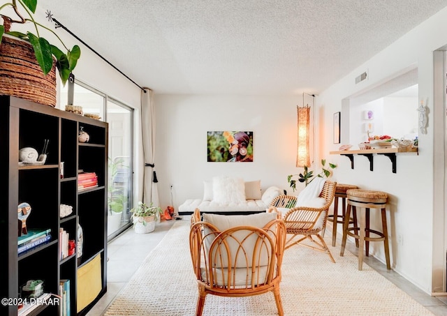 1600 Big Tree Rd Unit R4, Daytona Beach, FL 32119 - tiled living room with a textured ceiling