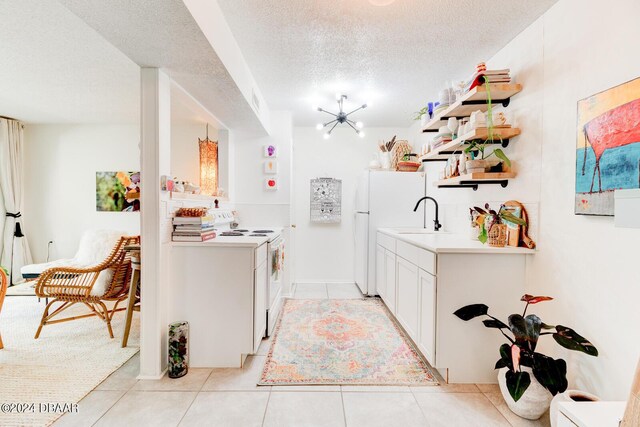 1600 Big Tree Rd Unit R4, Daytona Beach, FL 32119 - kitchen featuring white appliances, a textured ceiling, a sink, light tile patterned floors, and open shelves
