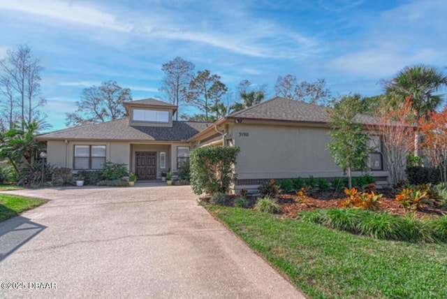 ranch-style house with a front lawn