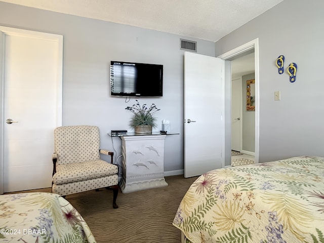 carpeted bedroom with a textured ceiling