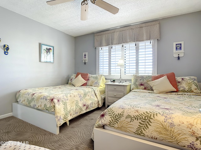 bedroom featuring ceiling fan and a textured ceiling