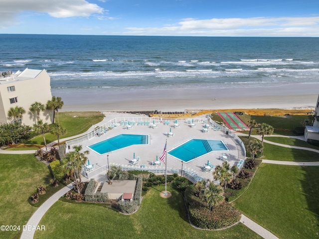 bird's eye view featuring a water view and a view of the beach