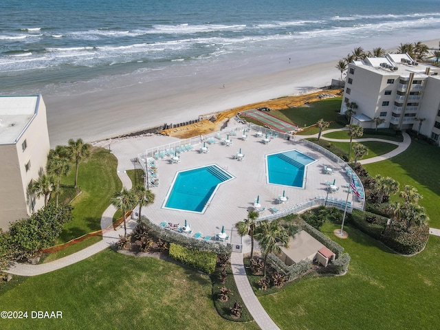 bird's eye view featuring a water view and a beach view