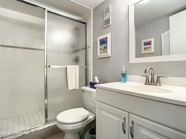 bathroom with toilet, an enclosed shower, and vanity