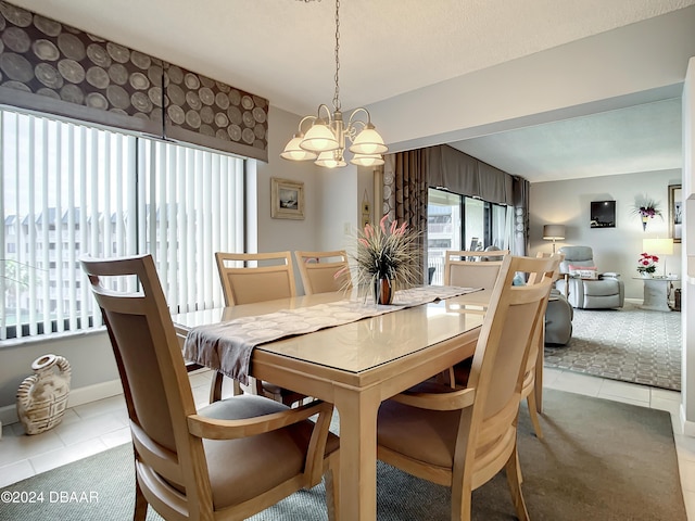 tiled dining area featuring a chandelier