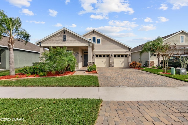 craftsman-style home featuring a garage and a front lawn