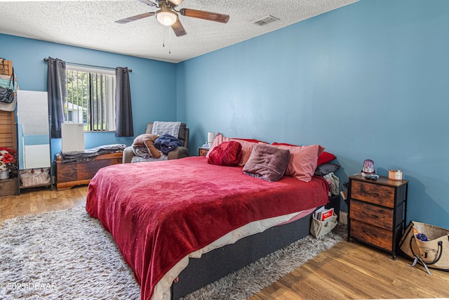 1724 Umbrella Tree Dr, Edgewater, FL 32132 - bedroom with wood finished floors, a textured ceiling, and a ceiling fan