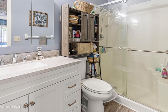 1724 Umbrella Tree Dr, Edgewater, FL 32132 - full bathroom with a shower stall, toilet, vanity, and wood finished floors