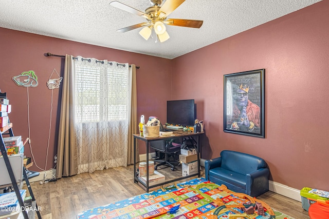1724 Umbrella Tree Dr, Edgewater, FL 32132 - home office featuring wood finished floors, ceiling fan, a textured ceiling, and baseboards