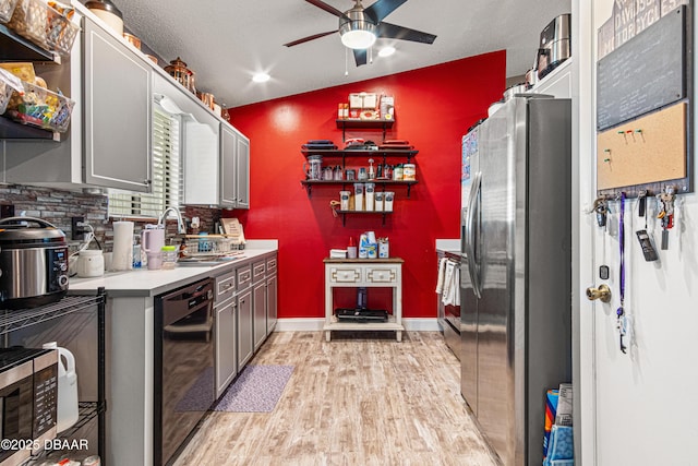 1724 Umbrella Tree Dr, Edgewater, FL 32132 - kitchen featuring a sink, stainless steel refrigerator with ice dispenser, black dishwasher, ceiling fan, and light wood finished floors