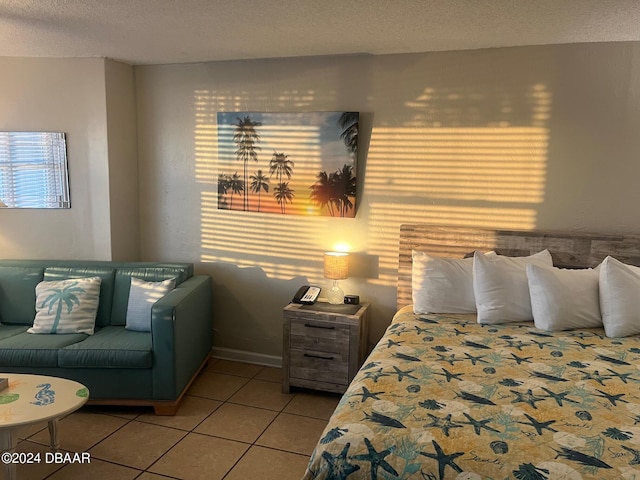 tiled bedroom with a textured ceiling