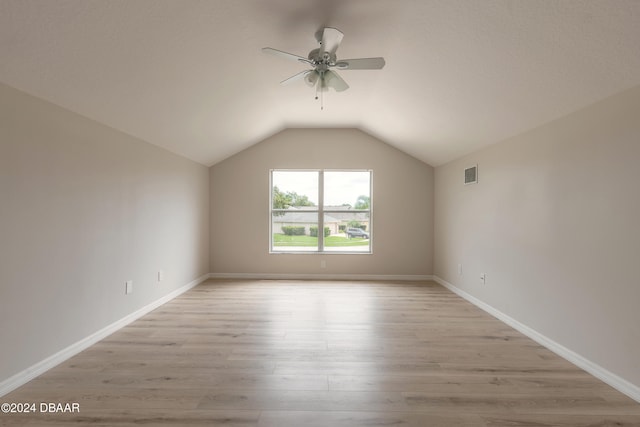 bonus room with light wood-type flooring, vaulted ceiling, and ceiling fan