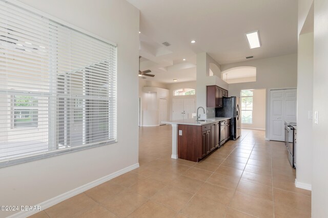 kitchen with stainless steel appliances, ceiling fan, light tile patterned floors, and sink