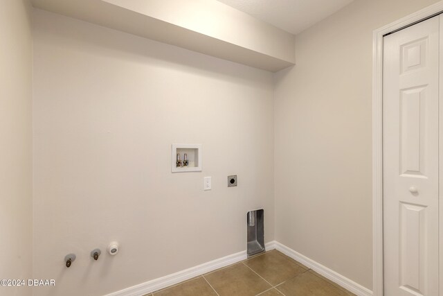 clothes washing area featuring gas dryer hookup, tile patterned flooring, hookup for a washing machine, and electric dryer hookup