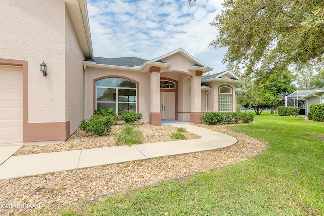 view of front of house featuring a front yard and a garage