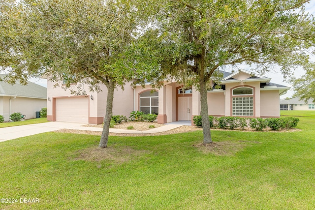 obstructed view of property featuring a front lawn and a garage