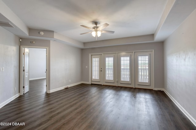 spare room featuring dark hardwood / wood-style flooring and ceiling fan