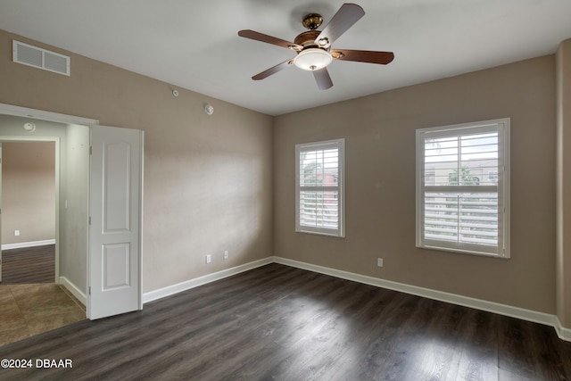 unfurnished room featuring ceiling fan and dark hardwood / wood-style floors